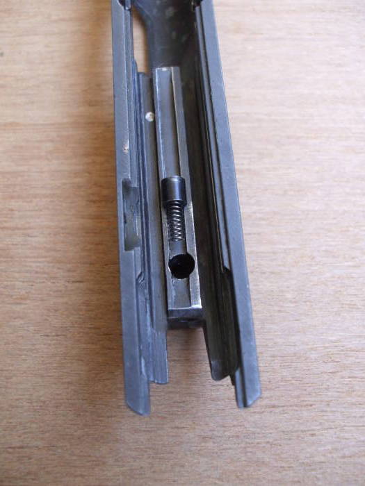 Firing pin detent being inserted into slide.